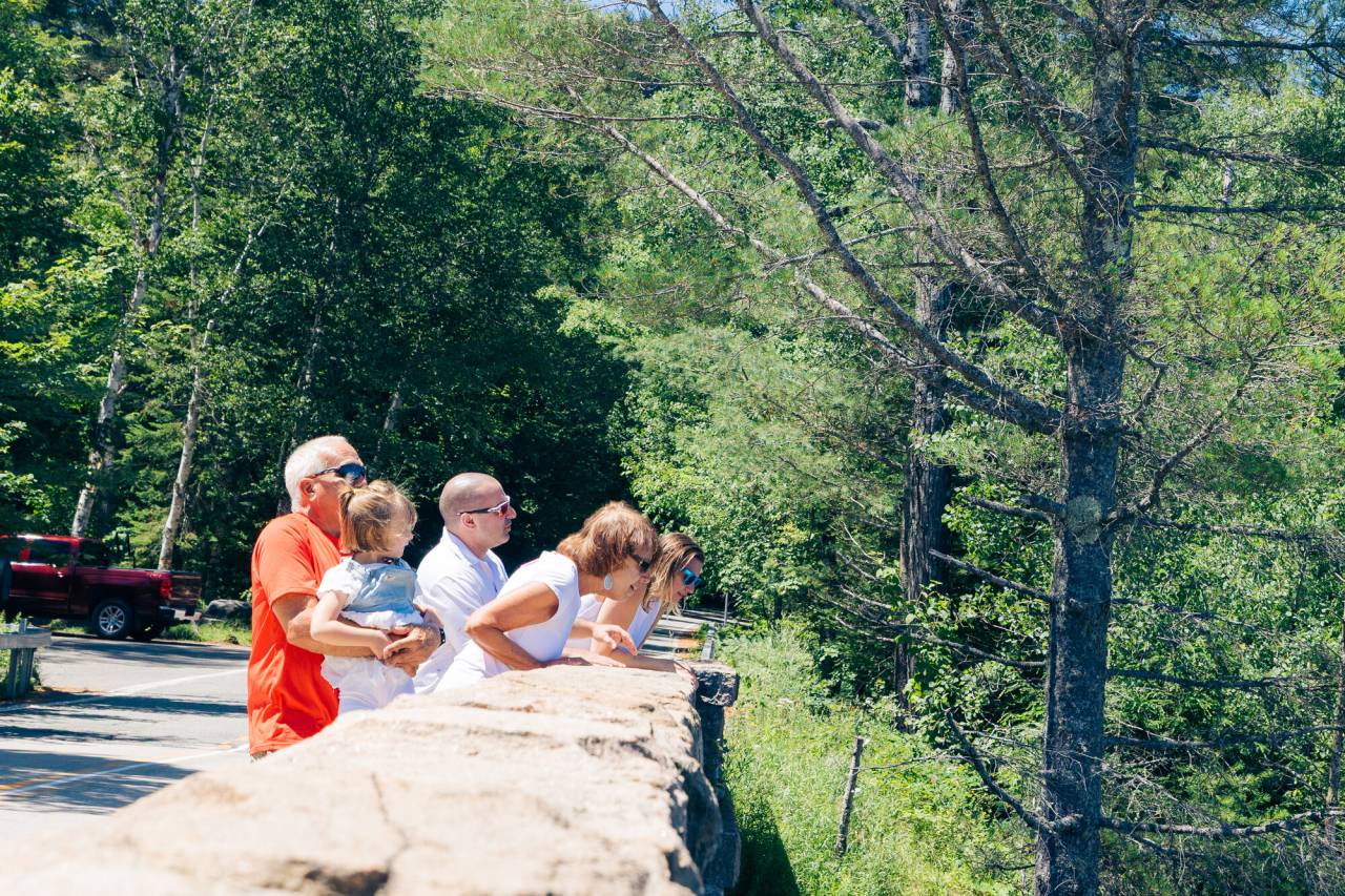 A family on the bridge at Bog River Falls